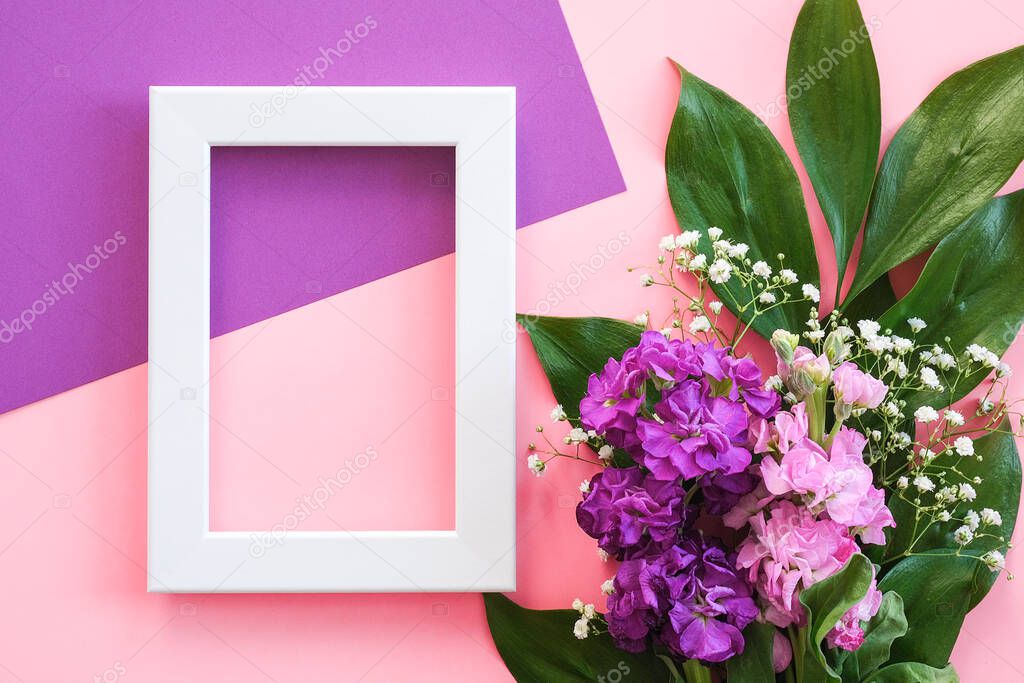 White frame and bouquet flowers on pink purple background. Greeting card Flat Lay Mockup Concept Hello summer, Mother's day, Womens day, Good day Template for text and design.