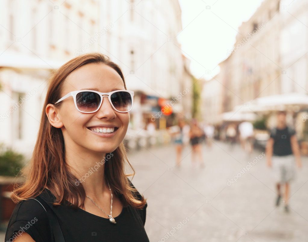 Smiling Woman on the Background of European Old Town Street