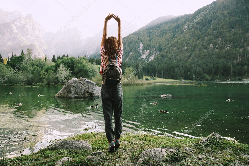 Traveler with raised arms up on the nature