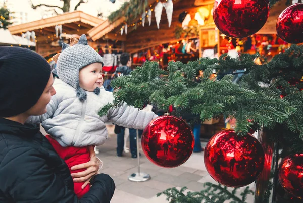 Happy family spend time at a Christmas street market and fair — Stock Photo, Image