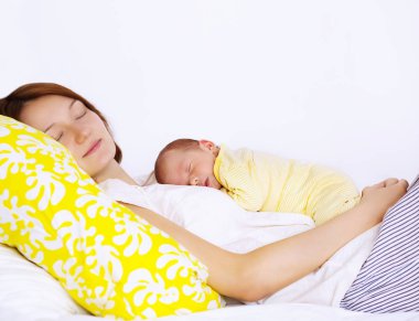 Mother and baby boy sleeping together clipart