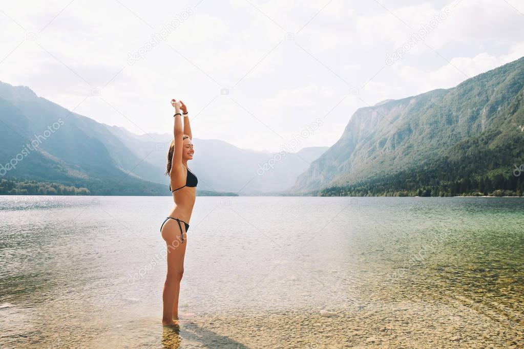 Woman on the nature background with mountain lake