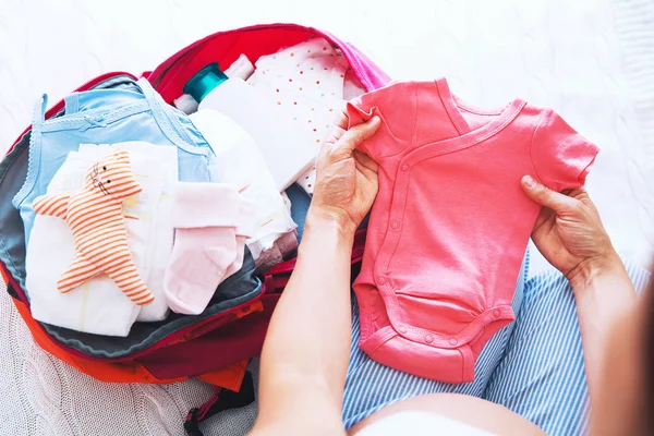 Pregnant woman packing suitcase, bag for maternity hospital — Stock Photo, Image