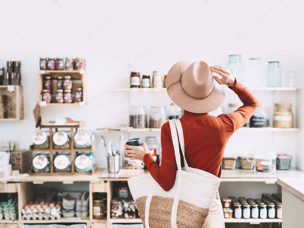 Young woman in zero waste shop. 