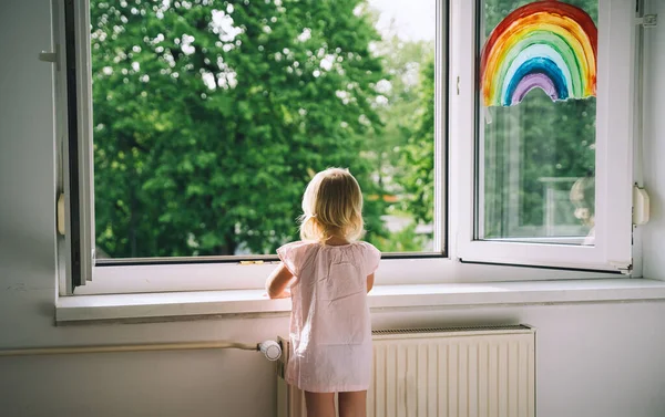 Маленькая Девочка Смотрит Открытое Окно Весеннее Время Рисует Радугу Окне — стоковое фото
