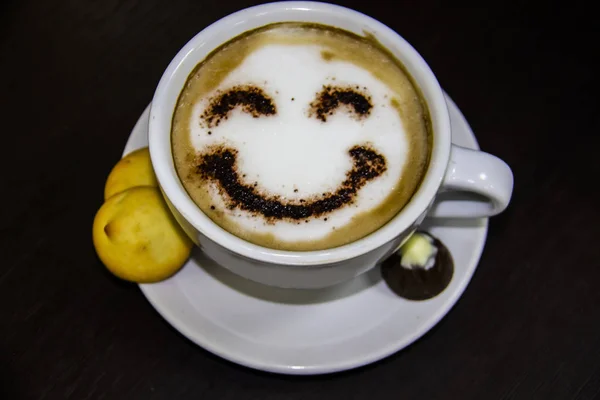 the cup of coffee with smile on the table.  Smile. Be happy with coffe