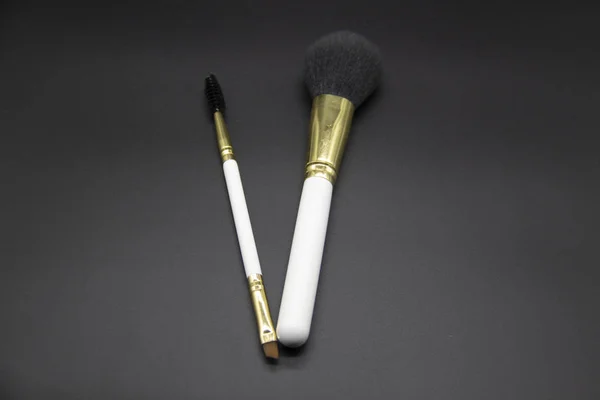 A Makeup brushes on a black background