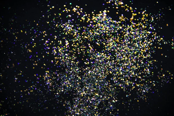 A colorful glitter on black background. Decorative colorful circles in the background