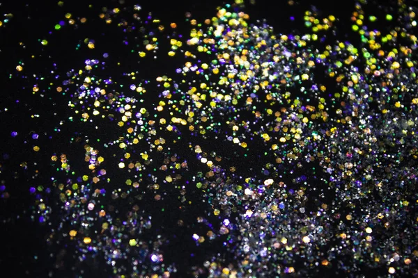 A colorful glitter on black background. Decorative colorful circles in the background