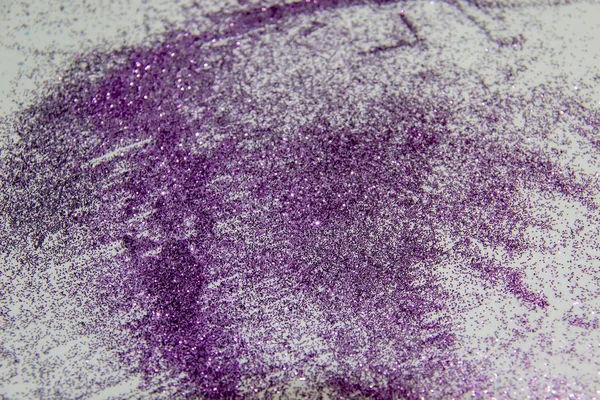 A purple glitter. Composition with glitter against background. Beautiful and textured background