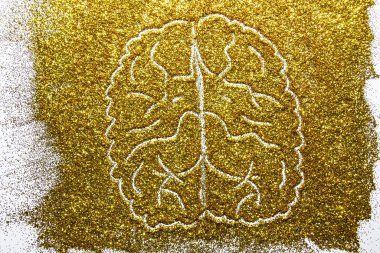 a composition with brain on beautiful gold glitter. Background and texture of gold glitter. Luxury gold glitter sparkle shining texture background
