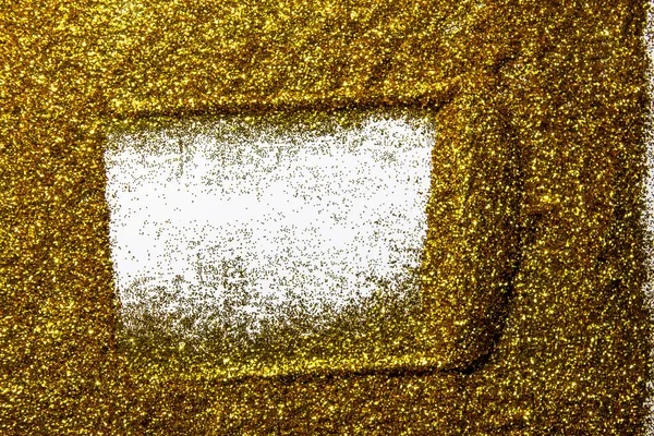 Drawing a frame on the golden sand glitter. A frame against a gold texture on the glitter background. A Shiny gold glitter on the background