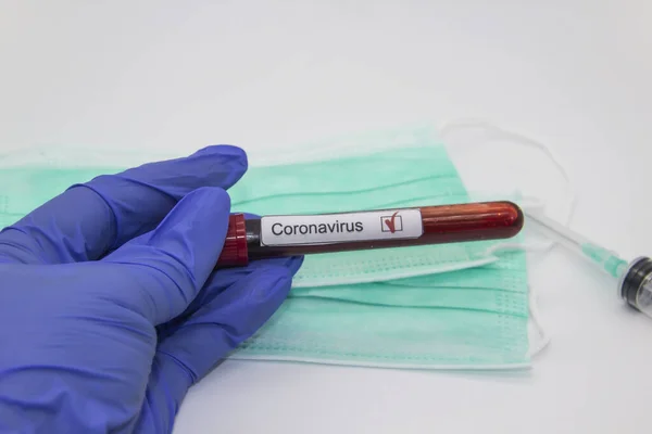 Coronavirus blood test 2019.Coronavirus came from Wuhan, China. Doctor hand in medical glove holding test tube with Coronavirus positive blood in laboratory. Concept can be used in the design