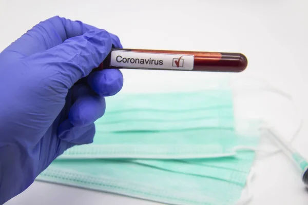 Coronavirus blood test 2019.Coronavirus came from Wuhan, China. Doctor hand in medical glove holding test tube with Coronavirus positive blood in laboratory. Concept can be used in the design