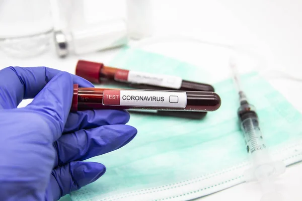 Coronavirus blood test 2019-2020.Coronavirus came from Wuhan, China. Doctor hand in medical glove holding test tube in laboratory. Concept can be used in the design