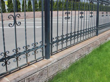 Şehrin otoparkına yakın temiz çitler ve temiz çimenler.