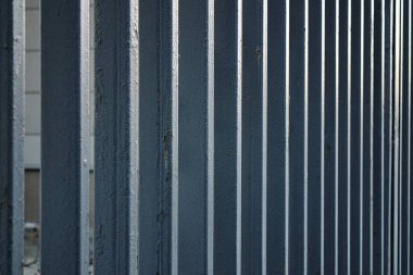 perspective: metal painted fence on the street