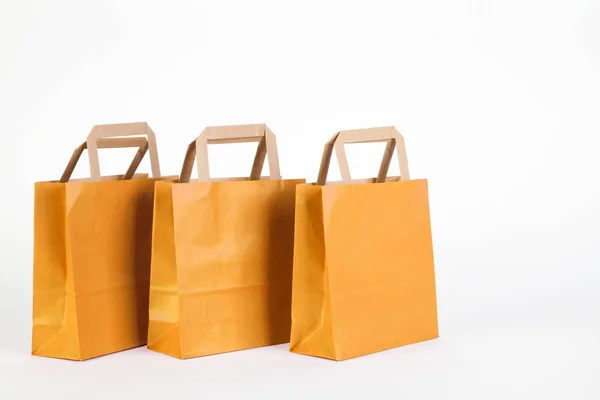 Three yellow shopping bags — Stock Photo, Image