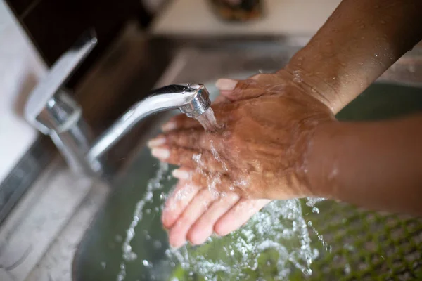 Thorough washing of hands under a tap