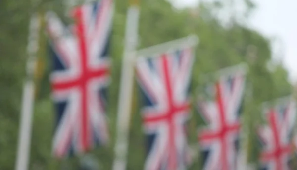 Many defocussed Union Jack flags background copy space — Stock Photo, Image