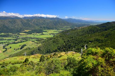 Beautiful New Zealand landscape with mountains and grassland. View from Takaka Hill, South Island. clipart