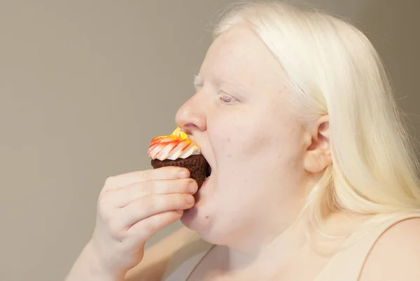 Woman Eating Cupcake Stock Image