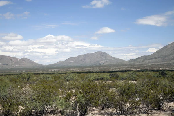 Montañas contra un cielo azul y un primer plano verde — Foto de Stock