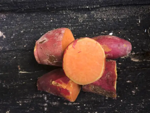 Sweet potato on wooden background — Stock Photo, Image