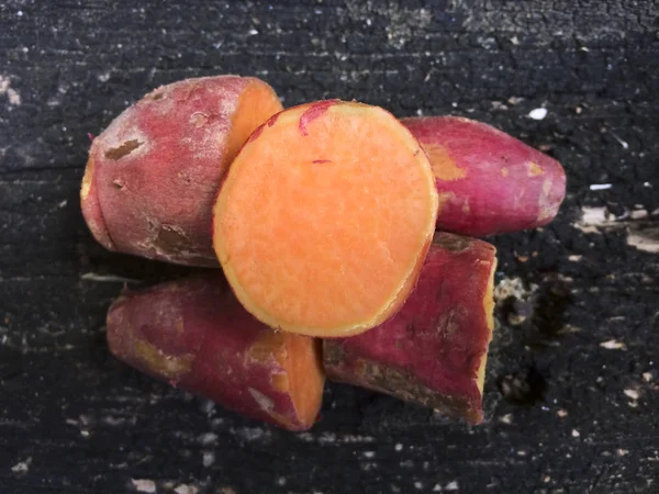 Sweet potato on wooden background — Stock Photo, Image