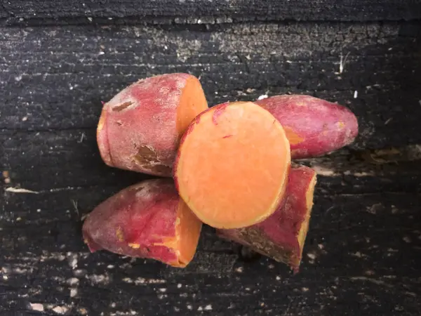 Sweet potato on wooden background — Stock Photo, Image