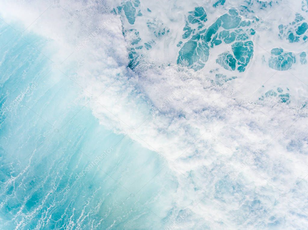 Aerial top down view of a beautiful turquoise Ocean wave in Hawaii