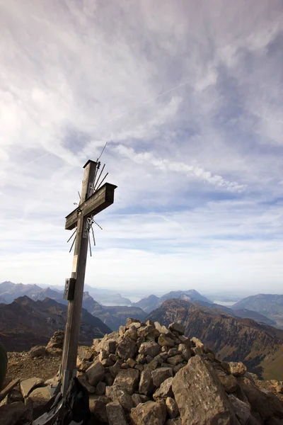 Sumit cross and evening mood on the top of a mountain