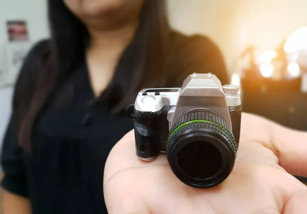 Vrouw met camera speelgoed in haar hand — Stockfoto