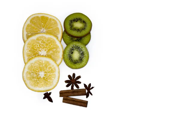 Mugs of kiwi and lemon sticks of cinnamon cloves on a white back — Stock Photo, Image