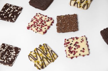 Bir sürü güzel renkli kurabiye beyaz bir torba üzerinde çikolatayla