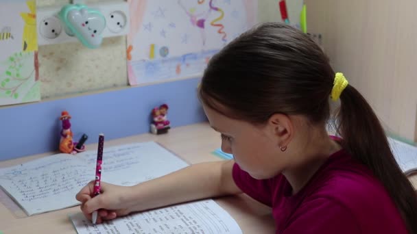 Girl Learns Lessons Home Carefully Reads Task Writes Pen Workbook — Stock Video