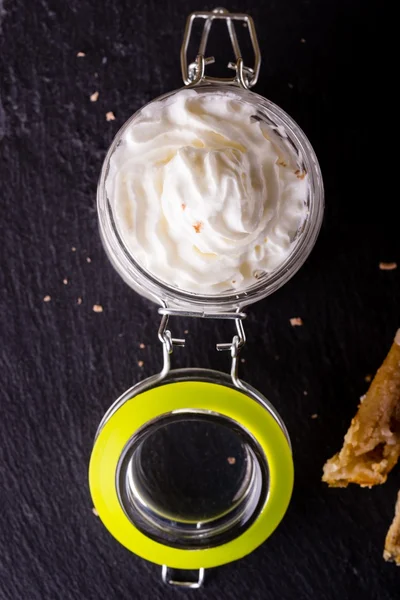 White whipped cream in glass jar with cover — Stock Photo, Image