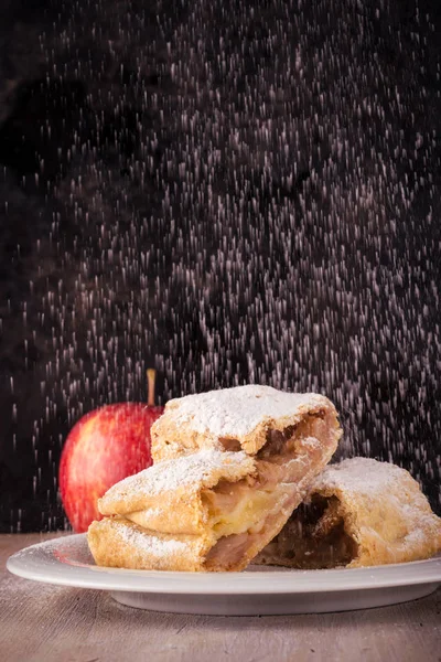 Two slices of apple strudel with spilled sugar — Stock Photo, Image