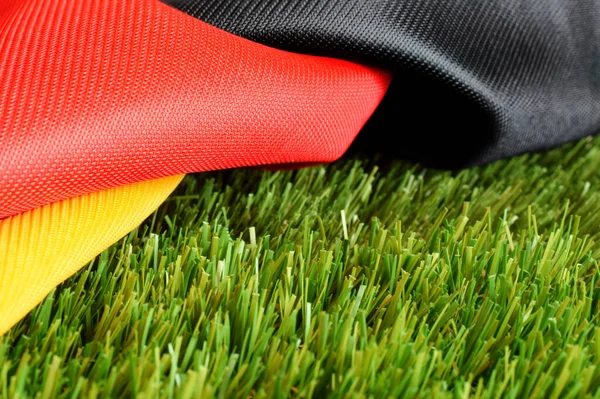 Football fan scarf in red black gold colors as national Germany flag rolled up
