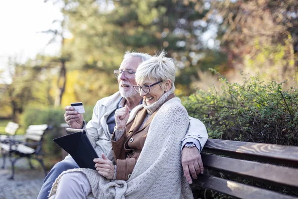 Mature man and woman shopping on line