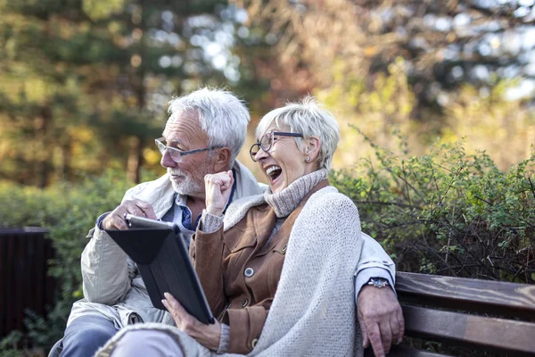 Mature man and woman shopping on line