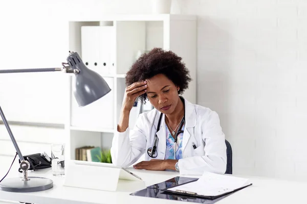 Woman doctor in ambulance office with stethoscope