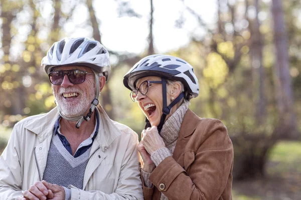 Old woman and man in park with bikes