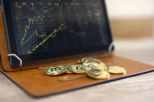 Crypto currency bitcoin on table with tablet