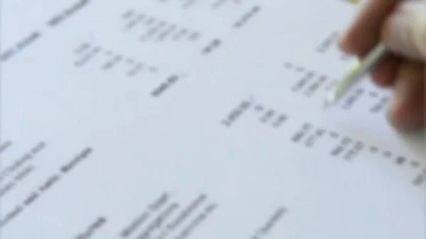 Tax time with tax forms and sinking in debt with small Filing with many blurry  tax forms before the deadline and tax day.