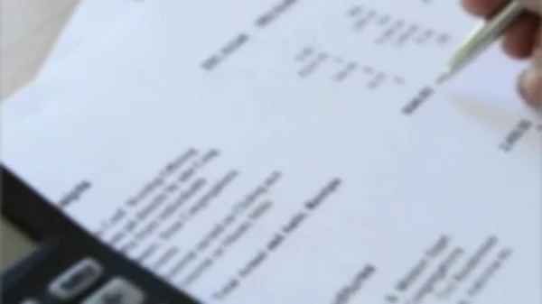 Tax time with tax forms and sinking in debt with small Filing with many blurry  tax forms before the deadline and tax day.