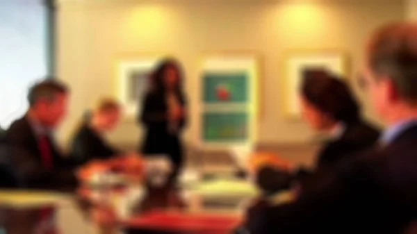 Blurred view of Colleagues meeting and setting issues for every person.