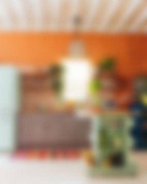 Ada, granit tezgah, paslanmaz çelik buzdolabı, fırın ve ahşap zemini olan çağdaş beyaz bir mutfağın içi.