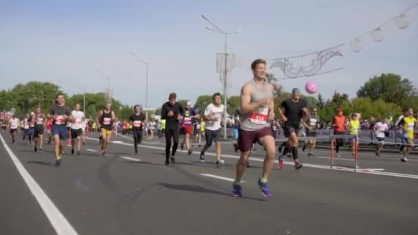 MINSK, BELARUS- SEPTEMBER 15, 2019: Deelnemers aan de halve marathon lopen op de snelweg. Massa marathon lopers race Stockvideo