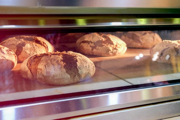 Rollos de pan cocidos en un horno industrial — Foto de Stock